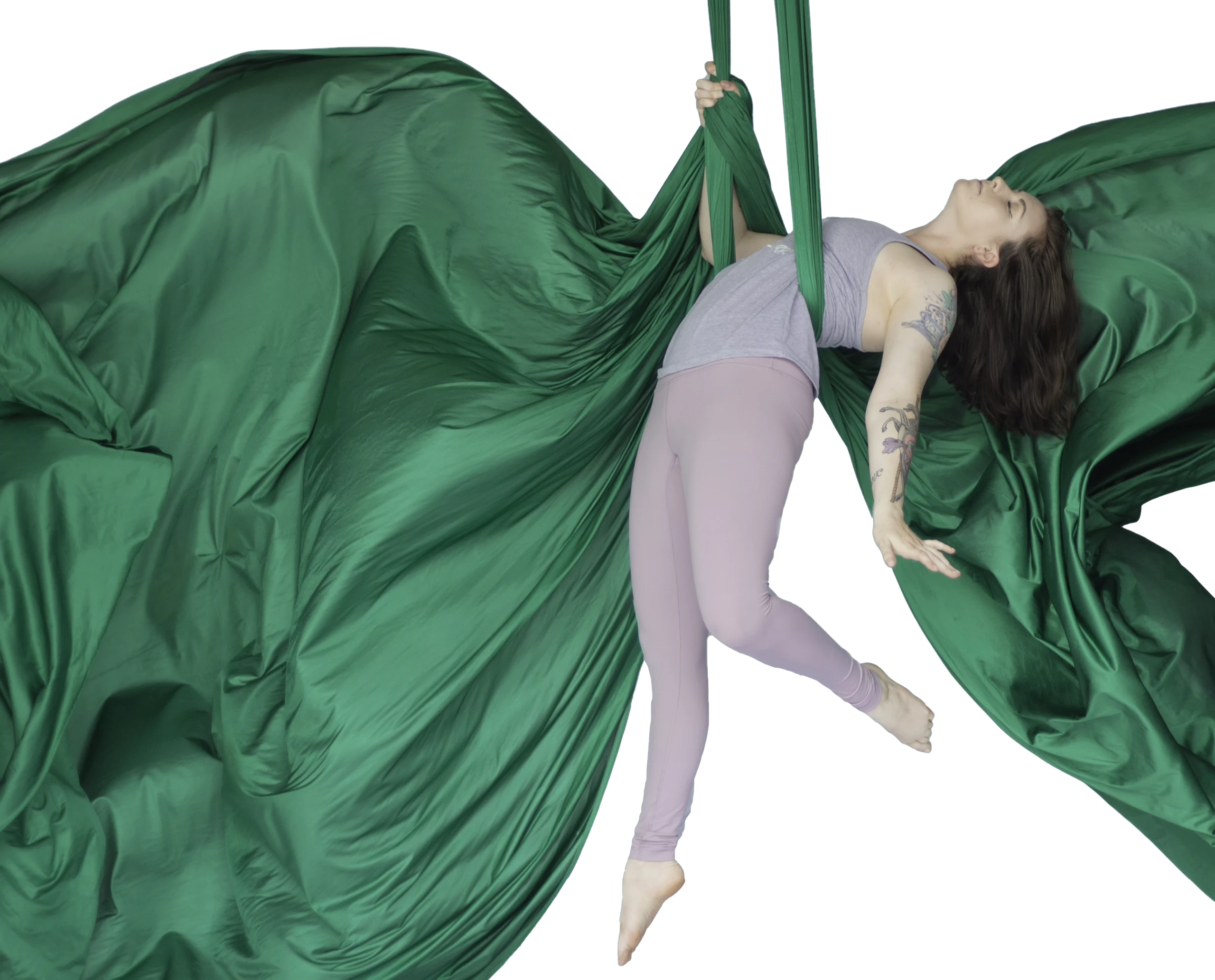 aerialist floating on green aerial silks